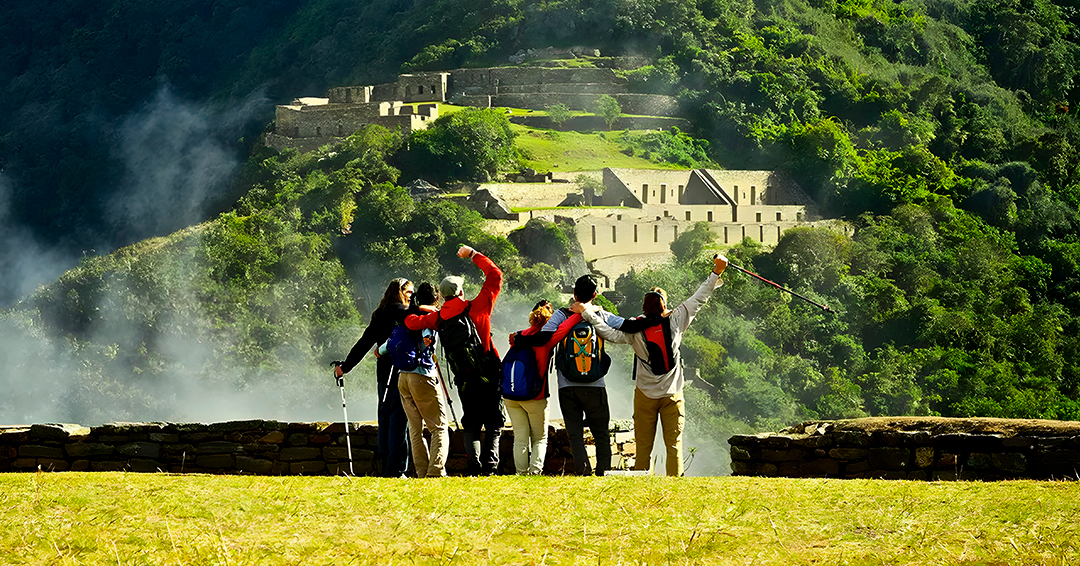 Travelers hiking along the remote mountain trail toward the Choquequirao archaeological site.