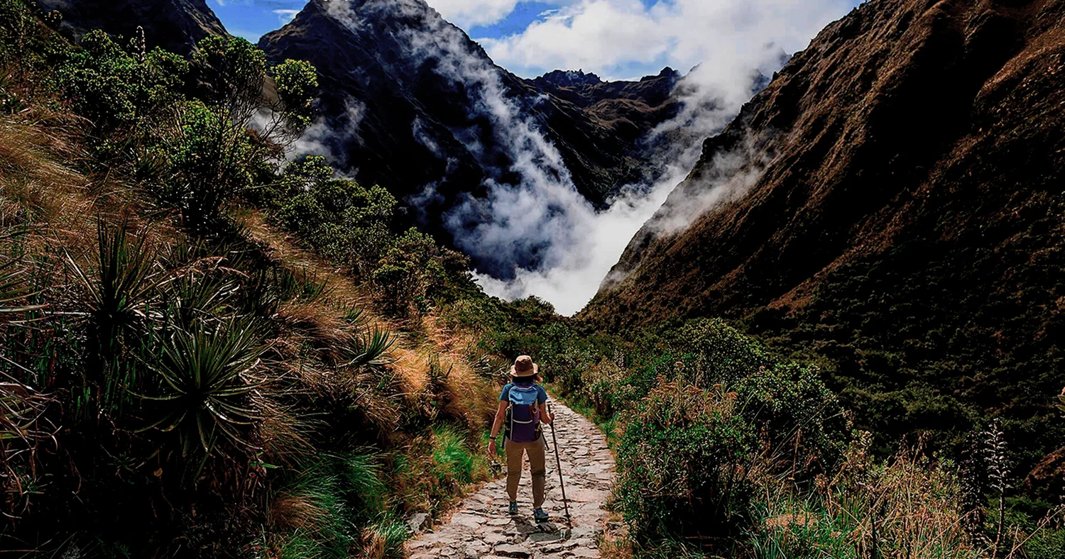 Hiker walking through the Andean landscape on the Salkantay Trek