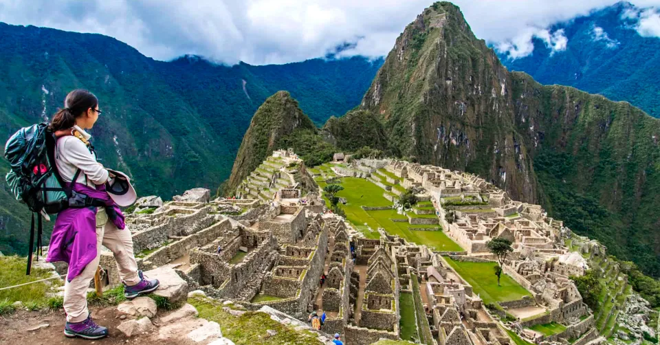 Landscape of the Machu Picchu archaeological sanctuary and surrounding lush green peaks with Peru Grand Travel