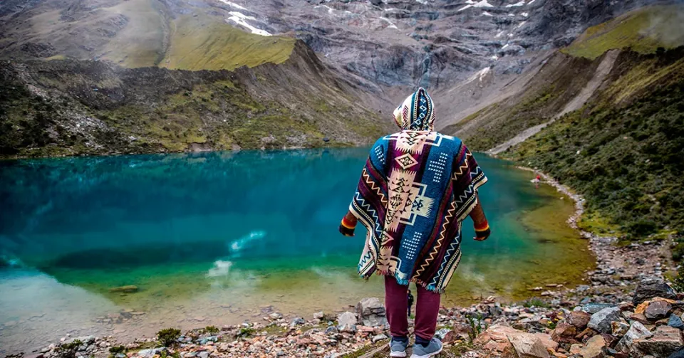 Turquoise Humantay Lake surrounded by snow-capped mountains near Cusco, Peru