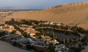 Huacachina Oasis surrounded by desert sand dunes in Peru