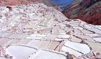 Panoramic view of the white salt evaporation ponds at Maras Salt Mines in the Sacred Valley of Peru