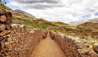 Stone pathway between ancient walls at Pikillacta archaeological site near Cusco, Peru