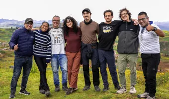 Group of travelers posing together with local guides in the Sacred Valley near Cusco, Peru