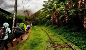 Hikers walking beside the railway during the Salkantay Trek to Machu Picchu