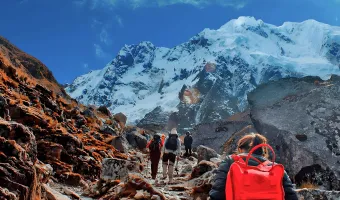 Hikers trekking through snow-capped mountains on the Salkantay route in Peru