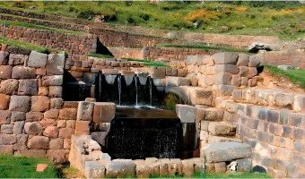 Flowing water through stone channels at Tipon archaeological site near Cusco, Peru