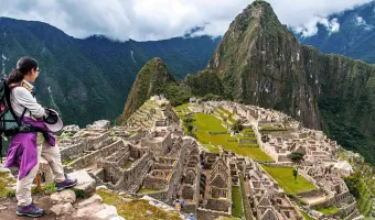 Traveler overlooking the Machu Picchu Inca citadel in Peru